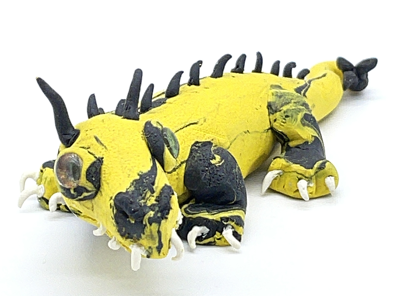 A yellow and black dragon with spikes along it's spine.